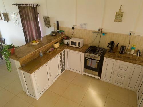 a kitchen with a counter top and a microwave at Le Paradisier Guest House in Rodrigues Island