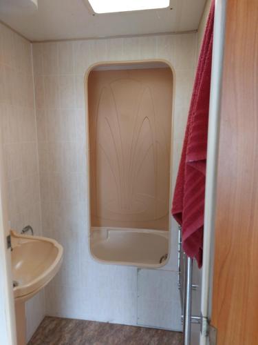 a small bathroom with a sink and a tub at Braemar Equestrian, East Riding of Yorkshire in Burton Pidsea