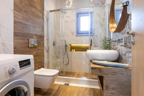 a bathroom with a shower and a toilet and a sink at Crystal Villa III in Chrissi Akti