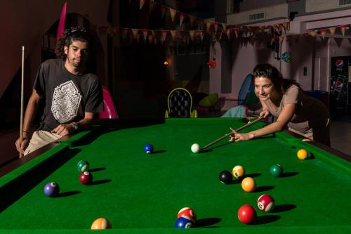 a man and a woman playing a game of pool at Abraham Eilat in Eilat
