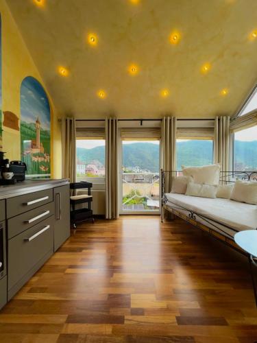 a large room with a bed and large windows at PARK VILLA zentral am Mittelrhein Zimmer&Apartments Self check in Aparthotel in Boppard
