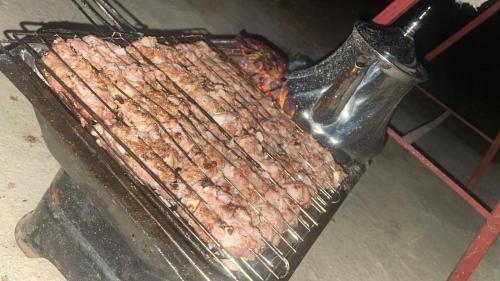 a bunch of meat cooking on a grill at La Belle Etoile in Ouazzane