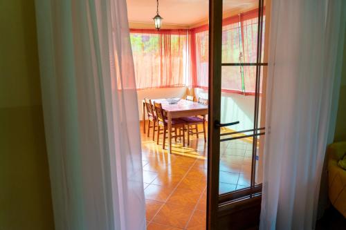a view of a dining room with a table and chairs at Apartments MoonRiver in Bihać