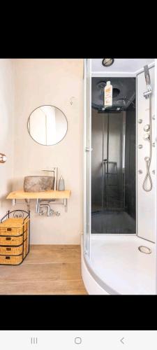 a bathroom with a shower with a mirror and a table at Tu refugio in Montbrió del Camp