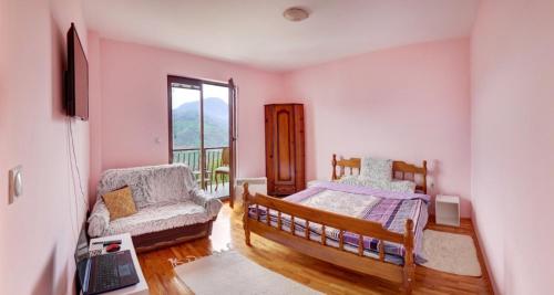 a bedroom with two beds and a chair and a window at Smestaj Rakovic in Pribojska Banja