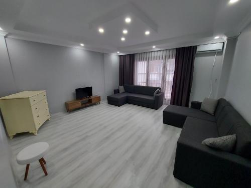 a living room with two couches and a television at ÇOLAK SUIT in Arsin