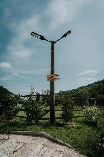 a street light on a wooden pole in the grass at Apartments MoonRiver in Bihać
