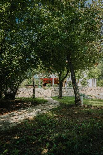 a park with trees and a picnic table in the background at Apartments MoonRiver in Bihać