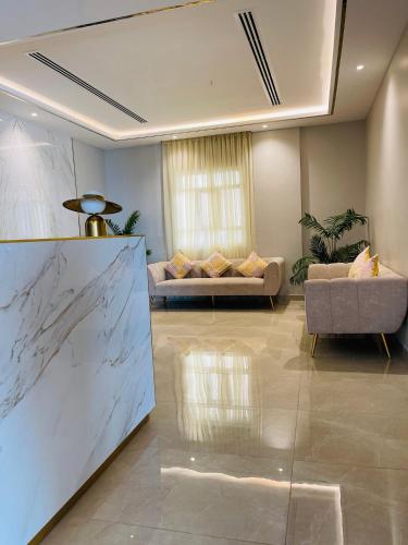 a living room with a couch and a table at Husin Al Khaleej Hotel Apartment in Seeb