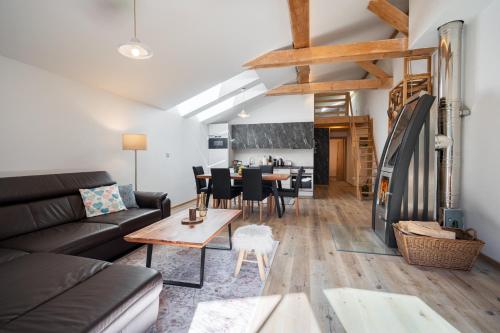 ein Wohnzimmer mit einem Sofa und einem Tisch in der Unterkunft Apartments Srdiecko-Chopok-Sauna in Smaller apt-Views-Hiking-Fire place-Kids corner in Tale