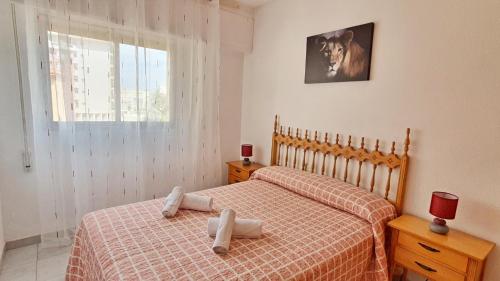 a bedroom with two beds with towels on them at EUROPA I - Playa de Miramar in Miramar