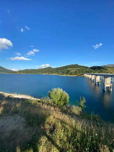 a bridge over a body of water at Casa vacanze Lago di Campotosto in Campotosto