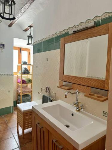 a bathroom with a sink and a mirror at Los Molinos Quesada in Quesada