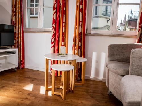 a living room with a table and a chair and a couch at Haus Triflinger in Lindau
