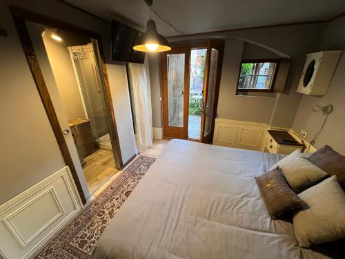 a bedroom with a large white bed and a mirror at Cabane Du Cerf in Llivia