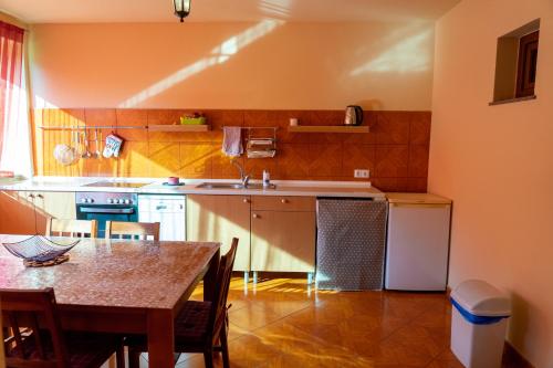 a kitchen with a table and a sink and a table and chairs at Apartments MoonRiver in Bihać