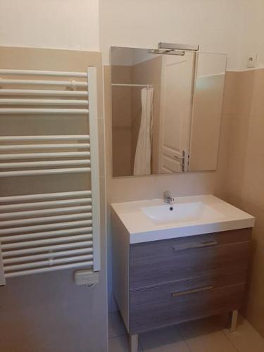 une salle de bain avec un lavabo et un miroir dans l'établissement Maison a la campagne entre Aix en Pce et Marseille, aux Pennes-Mirabeau