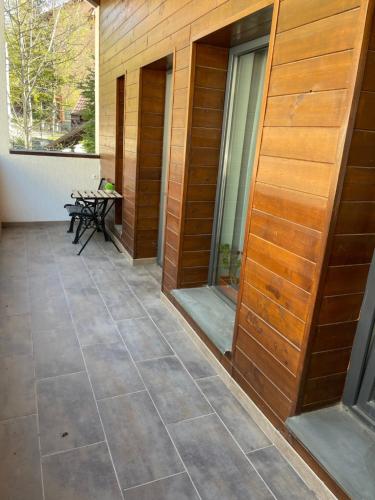 a patio with a table and benches on a building at Casa Larisa Antonia Apartment in Sinaia