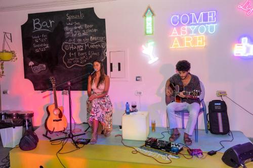 a man and a woman playing instruments in a room at Abraham Eilat in Eilat