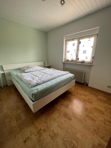 a bedroom with a bed and a large window at Kleine Wohnung mit schönem Blick in die Schweiz - Grenznah in Murg