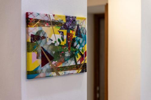 a painting is hanging on a wall at Apartmani Pero Dido in Rab