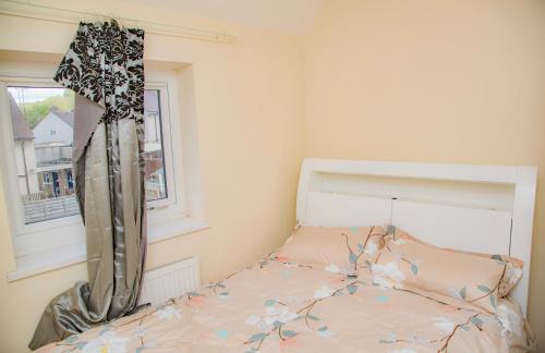 a bedroom with a bed and a window at White House in Netherton