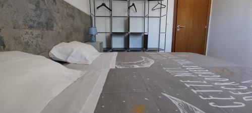 a bedroom with a bed with a sign on the floor at Apartamento Jardins D'Arriaga in Horta