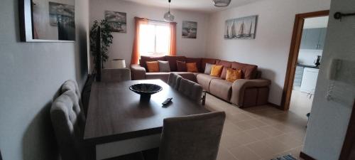 a living room with a couch and a table at Apartamento Jardins D'Arriaga in Horta