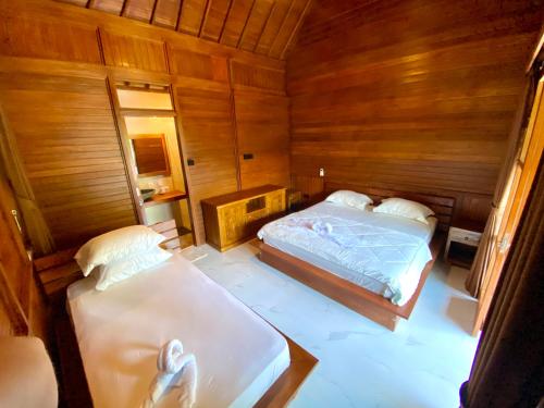 Кровать или кровати в номере Pondok Indah Bungalow Bingin
