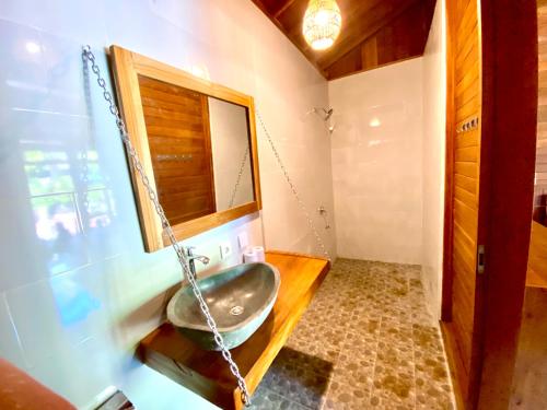a bathroom with a sink and a mirror at Pondok Indah Bungalow Bingin in Uluwatu