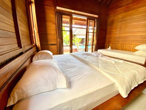 Кровать или кровати в номере Pondok Indah Bungalow Bingin