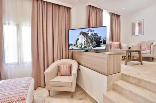 a living room with a television in a room at Lavanda Boutique Suites Tala Bay in Aqaba