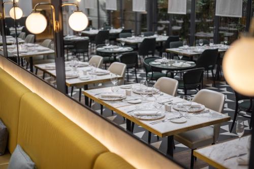 a row of tables and chairs in a restaurant at Century Old Town Prague - MGallery Collection in Prague