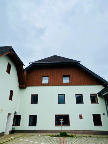 a large white building with a brown roof at Gutshof zum Wurzgarten in Hainbach