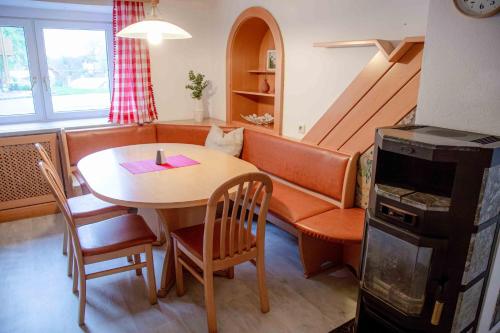 a living room with a table and a couch at Gutshof zum Wurzgarten in Hainbach