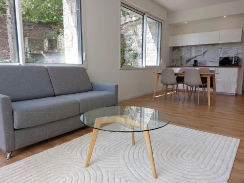 a living room with a couch and a table at La Villa Bompard 48M2 Cœur de ville avec terrasse in Rodez
