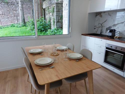 a wooden table in a kitchen with a table and chairs at La Villa Bompard 48M2 Cœur de ville avec terrasse in Rodez