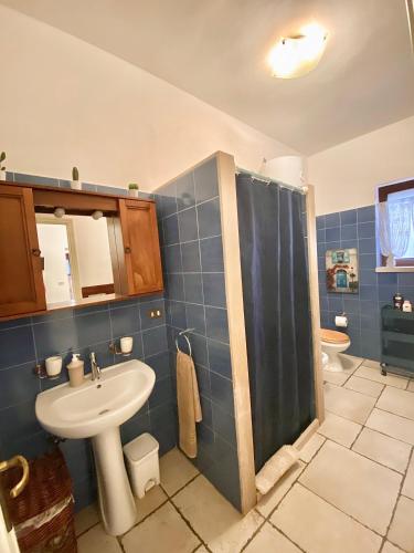 a bathroom with a sink and a shower at Trulli Caroli in Locorotondo