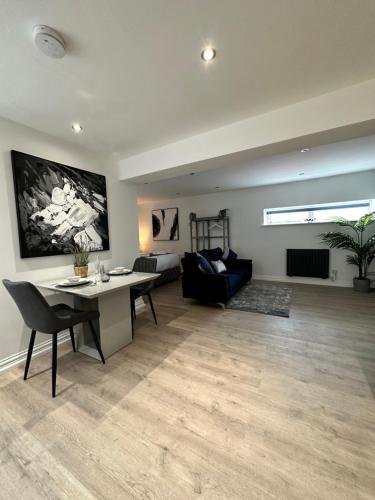 a living room with a table and a couch at The Cottage in Saint Annes on the Sea