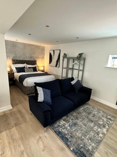 a living room with a bed and a couch at The Cottage in Saint Annes on the Sea