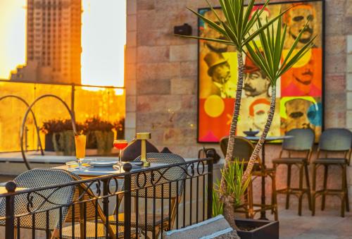 a patio with a table and chairs and a potted plant at Brown JLM Mamilla, a member of Brown Hotels in Jerusalem