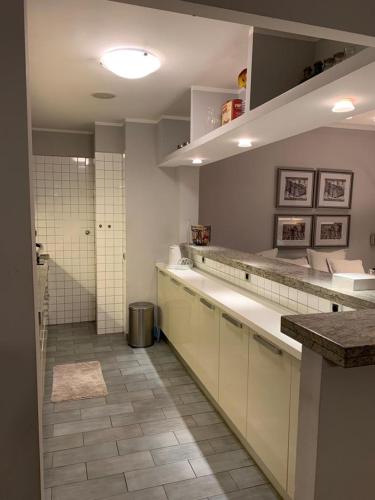 a large bathroom with a sink and a shower at Apollo Apartaments in Zagreb
