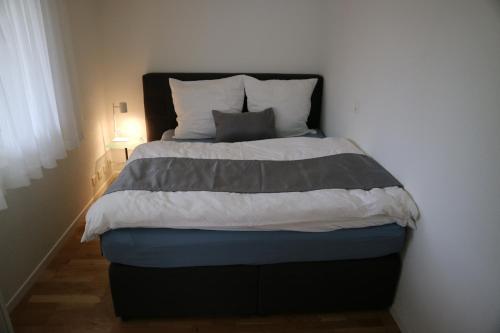 a bedroom with a bed with a blue and grey comforter at Studio CHic in Niederweningen