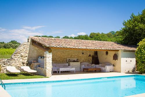 a small house with a swimming pool in front of it at Mas Pichony - Maison d'Hôtes - B&B in Pernes-les-Fontaines