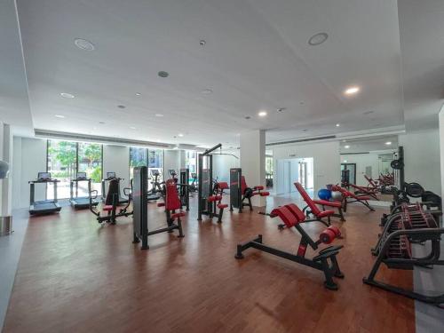 a gym with a lot of exercise equipment in a room at Vogue Vacation Homes, Madinat Jumeirah Living Rahaal Near Burj Al Arab One Bedroom Apartment with Balcony and Vibrant Community View, Access to all Amenities in Dubai