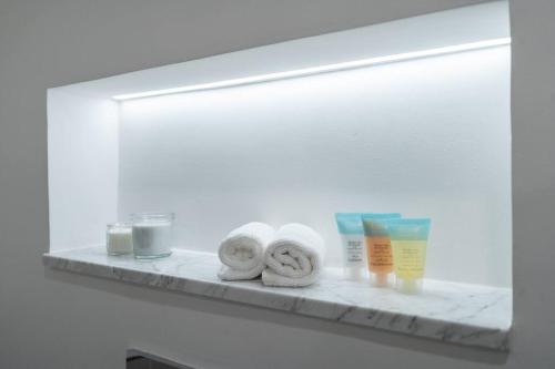 a shelf with towels and other products on it at Vogue Jumeirah Living - Near Burj Al Arab & Beach in Dubai