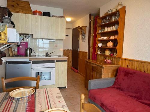 - une cuisine avec un canapé et une table dans une chambre dans l'établissement Appartement familial skis aux pieds avec parking à Samoëns 1600 - FR-1-624-15, à Samoëns