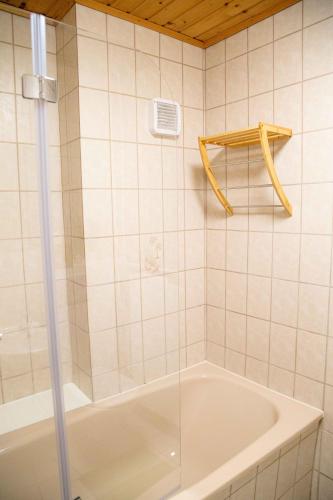 a bathroom with a tub and a glass shower at Gutshof zum Wurzgarten in Hainbach