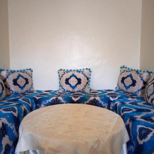 a room with two beds with blue and white pillows at Sahi family in Mejlaou