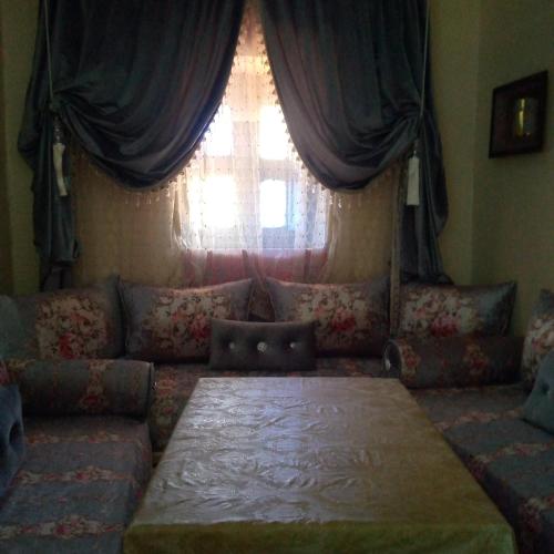 a living room with a couch and a window at Sahi family in Mejlaou
